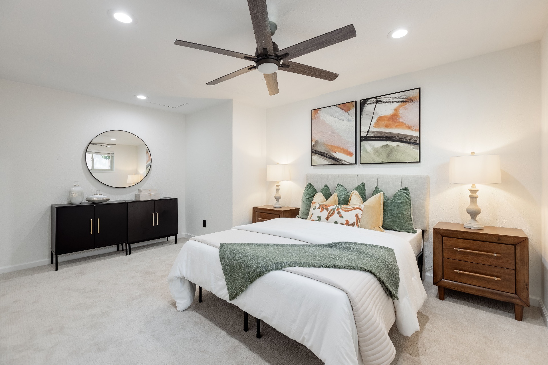Primary bedroom with tufted upholstered bed, layered linens, and soft morning light