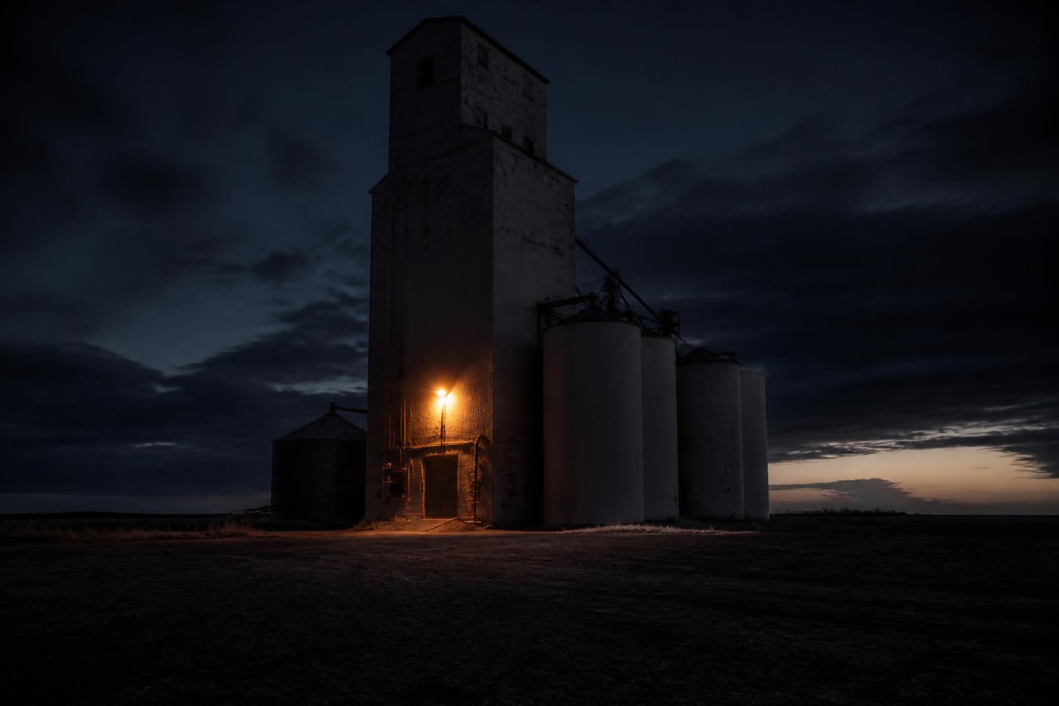 Painted illustration of Weld County, Colorado, with a tall weathered grain elevator and a small red barn standing over irrigated crop rows at golden hour.